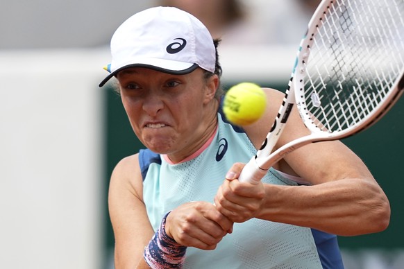 Poland&#039;s Iga Swiatek returns the ball to Alison Riske of the U.S. during their second round match of the French Open tennis tournament at the Roland Garros stadium Thursday, May 26, 2022 in Paris ...