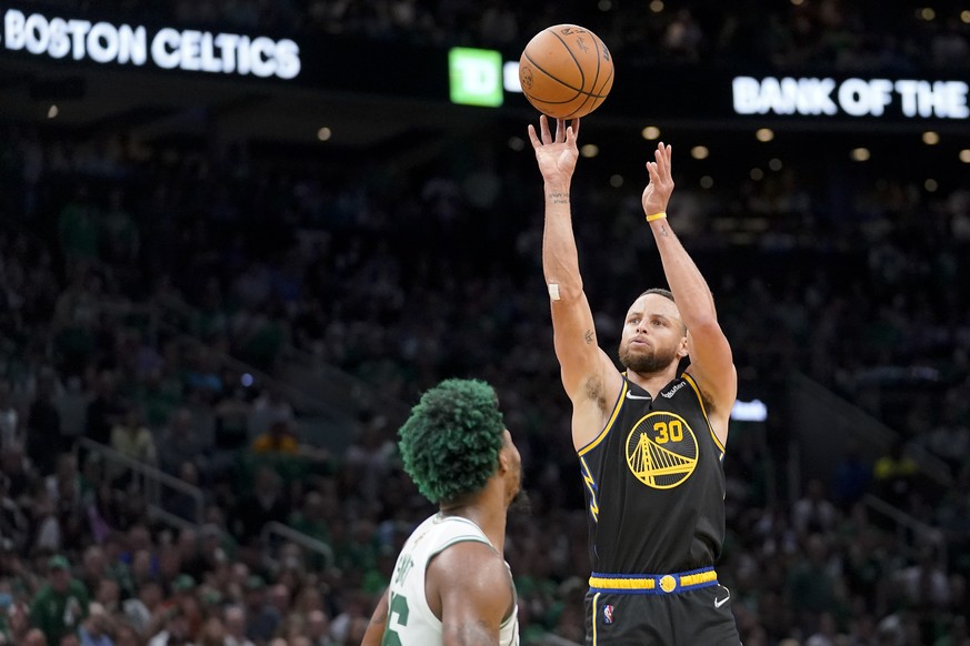Golden State Warriors guard Stephen Curry (30) puts up a shot against Boston Celtics guard Marcus Smart (36) during the third quarter of Game 3 of basketball's NBA Finals, Wednesday, June 8, 2022, in  ...