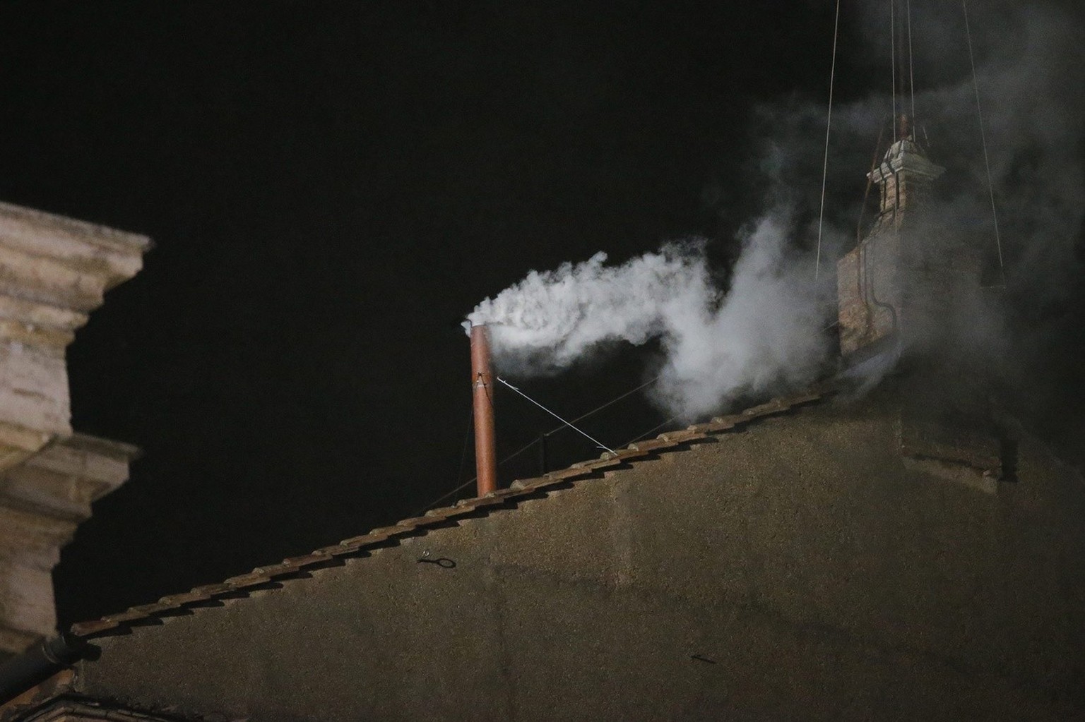epa03622400 White smoke rises from the chimney on the roof of the Sistine Chapel to indicate that the cardinals have elected a new pope on just the second day of their secret conclave at Vatican City, ...
