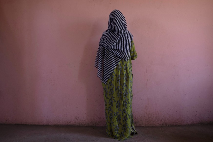 A Tigrayan woman who says she was gang raped by Amhara fighters, stands for a portrait in eastern Sudan, near the border with Ethiopia, on March 23, 2021. &quot;Let the Tigray government come and help ...
