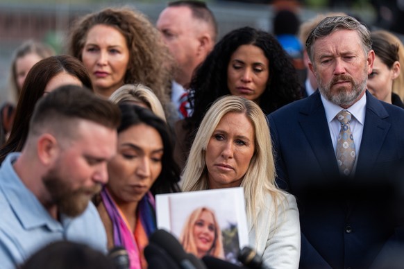 Rep. Marjorie Taylor Greene, R-Ga., second from right, and Rep. Thomas Massie, R-Ky., right, react during a news conference on the Epstein Files Transparency Act, Tuesday, Nov. 18, 2025, outside the U ...