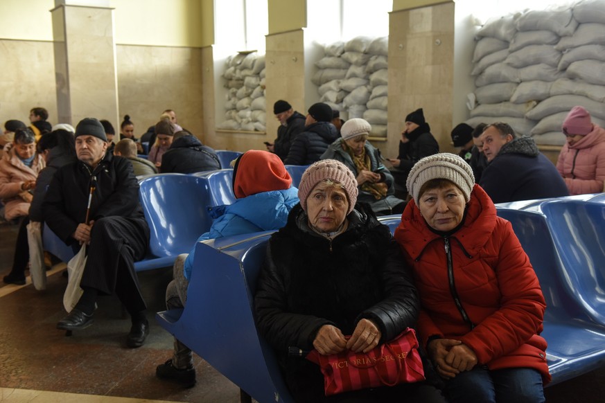epa10314294 People sit at the train station in Kherson, southern Ukraine, Nov. 19, 2022. About 200 people arrived in Kherson by train for the first time since Feb. 24 as Ukraine resumed…
