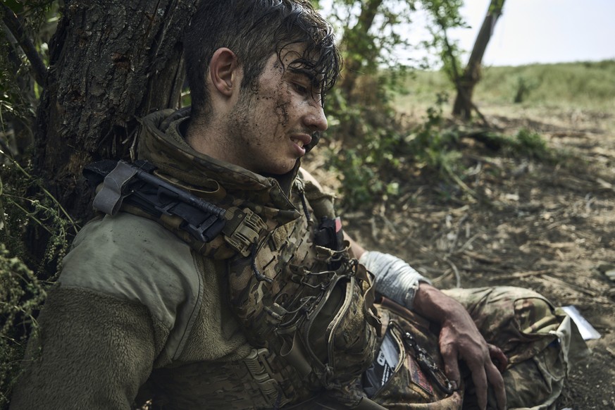 A wounded soldier of Ukraine&#039;s 3rd Separate Assault Brigade, call sign Polumya (Flame), 19, rests after he received first aid as he waits for evacuation near Bakhmut, Ukraine, Monday, Sept. 4, 20 ...