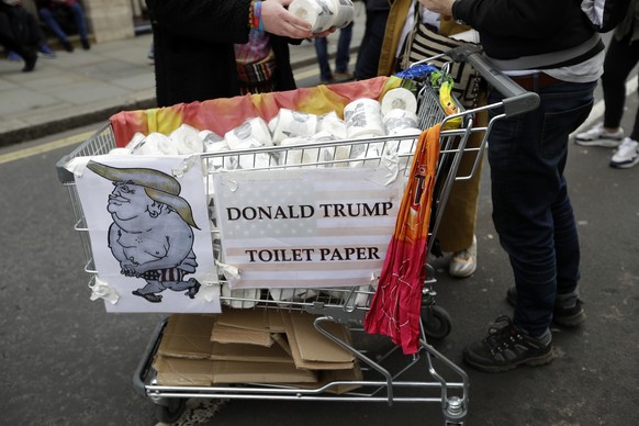 A man sells toilet paper with pictures of US President Donald Trump during a Peoples Vote anti-Brexit march in London, Saturday, March 23, 2019. The march, organized by the People's Vote campaign is c ...