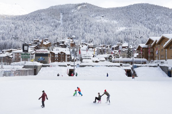 epa06428847 Ice skaters in Zermatt, Switzerland, 10 January 2018. Due to heavy snowfall and rain showers, Zermatt can only be reached by air. Swiss authorities have closed roads and train service into ...