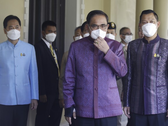 epa10534446 Thai Prime Minister Prayut Chan-o-cha (C) arrives to attend a weekly cabinet meeting after the dissolution of parliament for the upcoming general election, at the Government House in Bangk ...