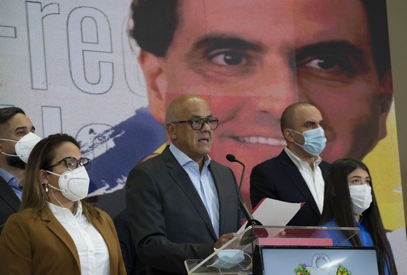 Venezuelan President of the National Assembly Jorge Rodriguez, center, speaks to the press as an image of Colombian businessman and Venezuelan special envoy Alex Saab is in the back in Caracas, Venezu ...