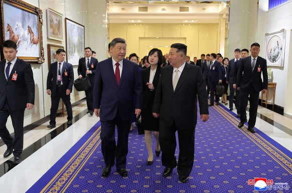 In this photo provided by the North Korean government, North Korean leader Kim Jong Un, right, and Chinese President Xi Jinping, left, walk to a venue for dinner in Pyongyang, Monday, June 8, 2026. In ...