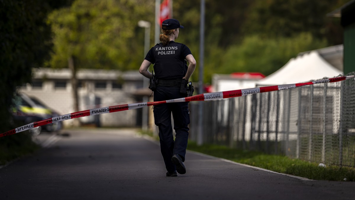 epa13202061 A police officer guards at the Schachen horse racing track, the site of a deadly rave party shooting incident, in Aarau, Switzerland, 31 August 2026. One person was killed, and five others ...