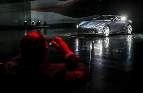 epa07995457 The Ferrari Roma car is unveiled in Rome, Italy, 14 November 2019. Italian carmaker Ferrari unveiled a new sports coupe aimed at enticing entry-level buyers and competing with the Porsche  ...