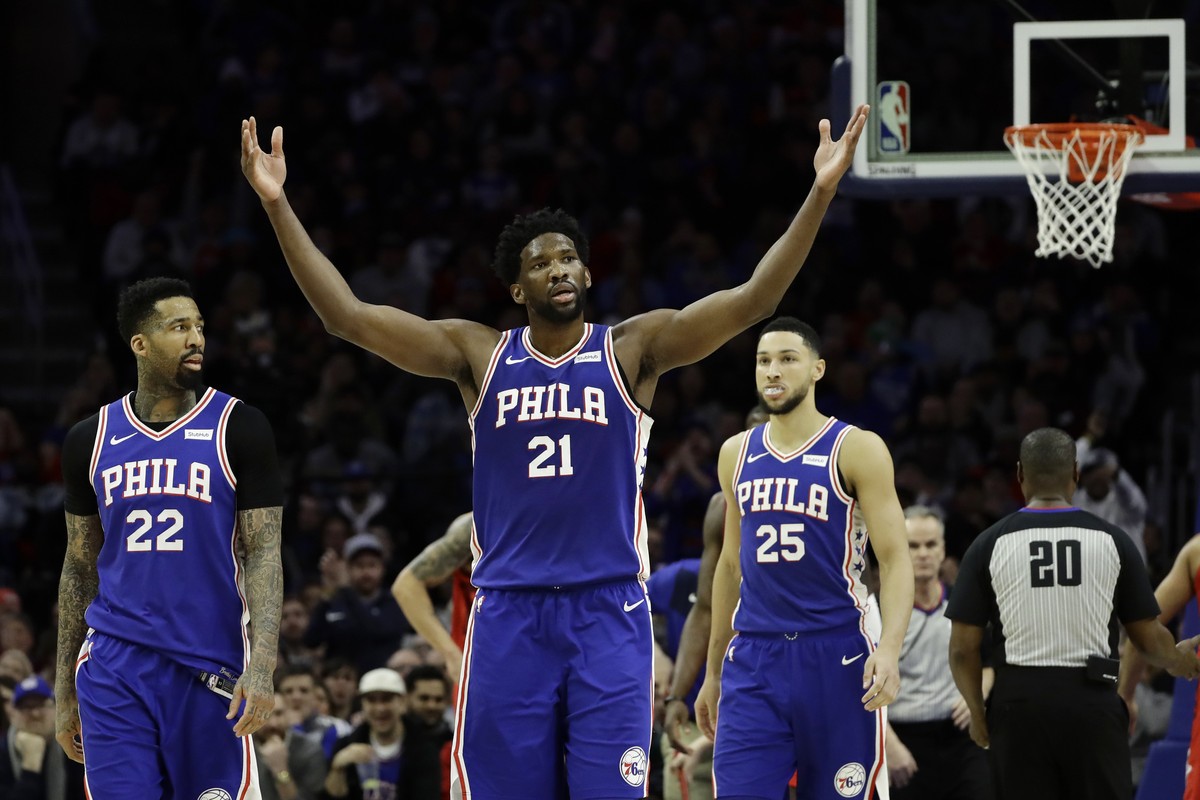 Philadelphia 76ers' Joel Embiid (21) reacts after drawing a foul as Wilson Chandler (22) and Ben Simmons look on during the first half of an NBA basketball game against the Houston Rockets, Monda ...