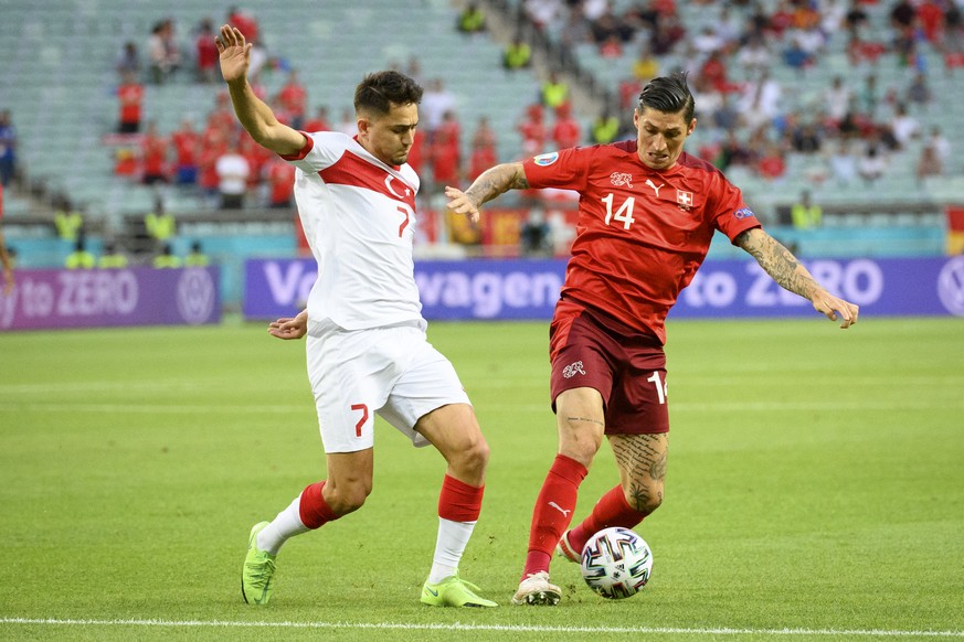 Turkey&#039;s forward Cengiz Under, left, in action against Switzerland&#039;s midfielder Steven Zuber, right, during the Euro 2020 soccer tournament group A match between Switzerland and Turkey at th ...