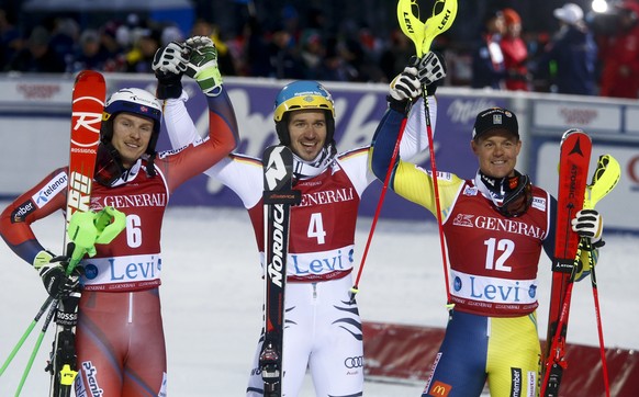 Germany's Felix Neureuther, center, winner of an alpine ski, men's World Cup slalom, poses with second placed Norway's Henrik Kristoffersen, left, and third placed Sweden's Mattias Hargin, in Levi, Fi ...