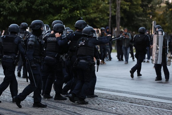 Police chase demonstrators during reactions to projected results after the second round of the legislative elections, Sunday, July 7, 2024 in Nantes, western France. Polls have closed in France, and p ...