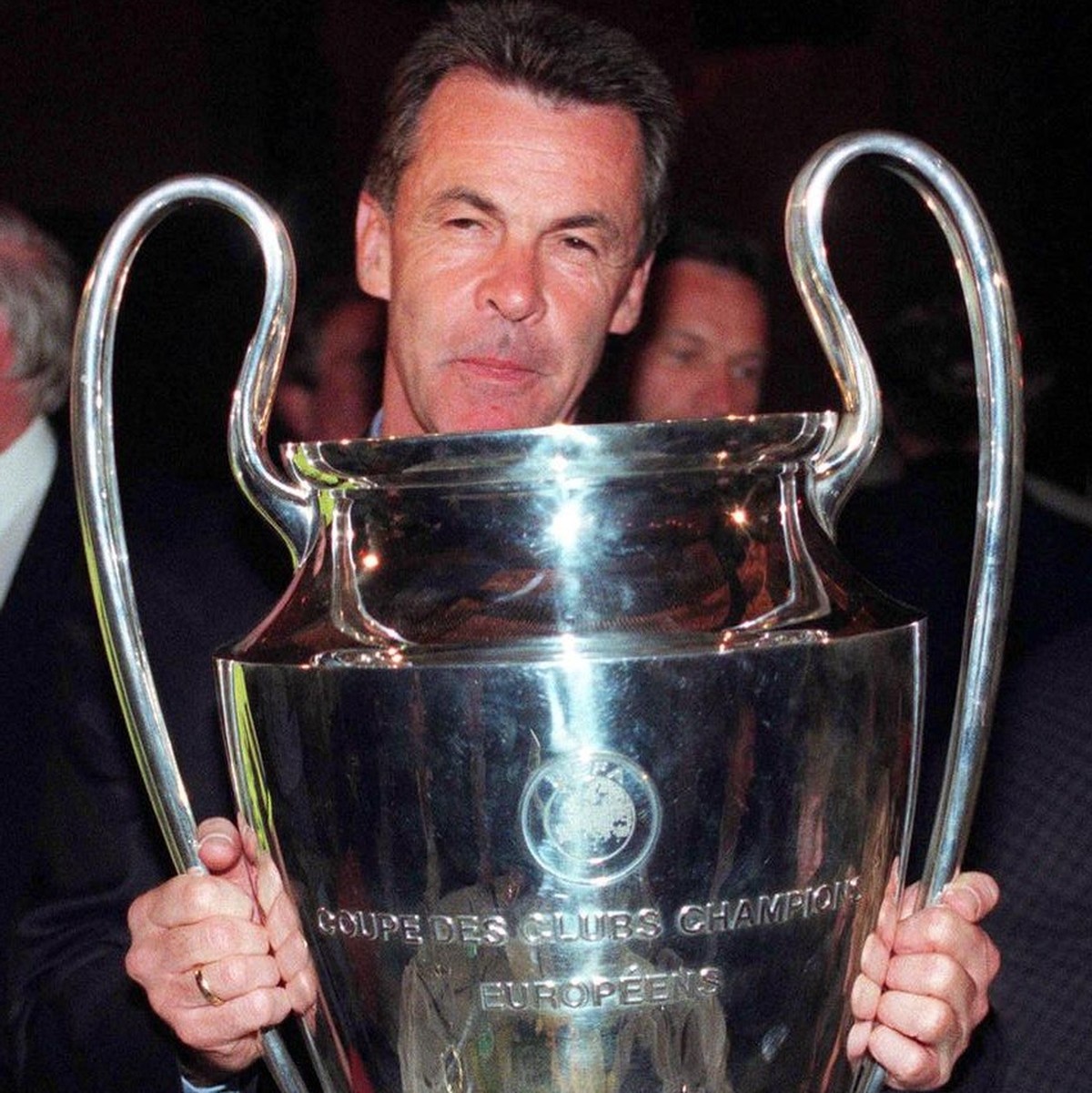Ottmar Hitzfeld, trainer of German team Borussia Dortmund, proudly displays the Champions League trophy after his side had upset favourites Juventus of Italy - last year's winners - with a three- ...