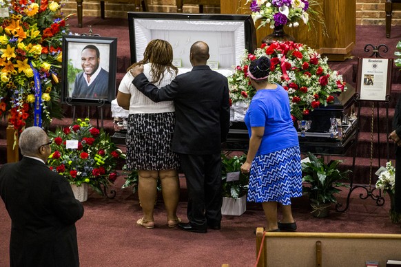 Mourners console each other during the public viewing before the funeral of Botham Shem Jean at the Greenville Avenue Church of Christ on Thursday, September 13, 2018 in Richardson, Texas. He was shot ...