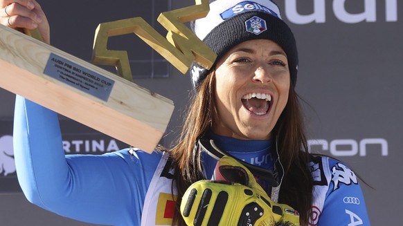 Italy&#039;s Elena Curtoni celebrates her first place on the podium of an alpine ski, women&#039;s World Cup super-G race in Cortina d&#039;Ampezzo, Italy, Sunday, Jan. 23, 2022. (AP Photo/Alessandro  ...