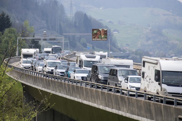 epa09891435 Cars and coaches heading south stand still in a traffic jam on the highway A2 between Amsteg and Beckenried on Good Friday, Switzerland, 15 April 2022. The traffic jam reached a maximum le ...