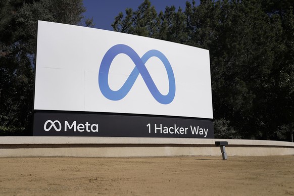FILE - Facebook&#039;s Meta logo sign is seen at the company headquarters in Menlo Park, Calif., Oct. 28, 2021. Federal regulators, Wednesday, July 27, 2022, took legal action to block Facebook parent ...