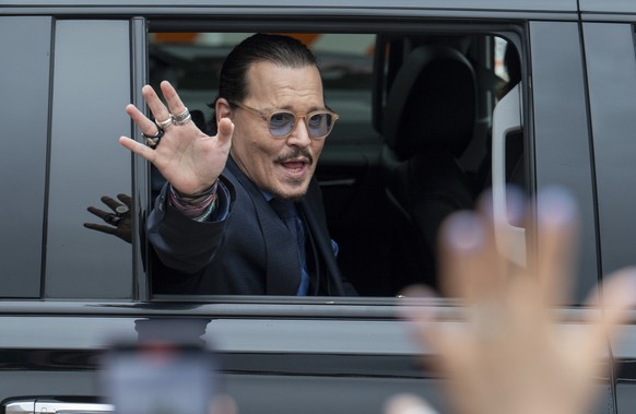 FILE - Actor Johnny Depp waves to supporters as he departs the Fairfax County Courthouse after closing arguments on May 27, 2022 in Fairfax, Va. Heard says she doesn