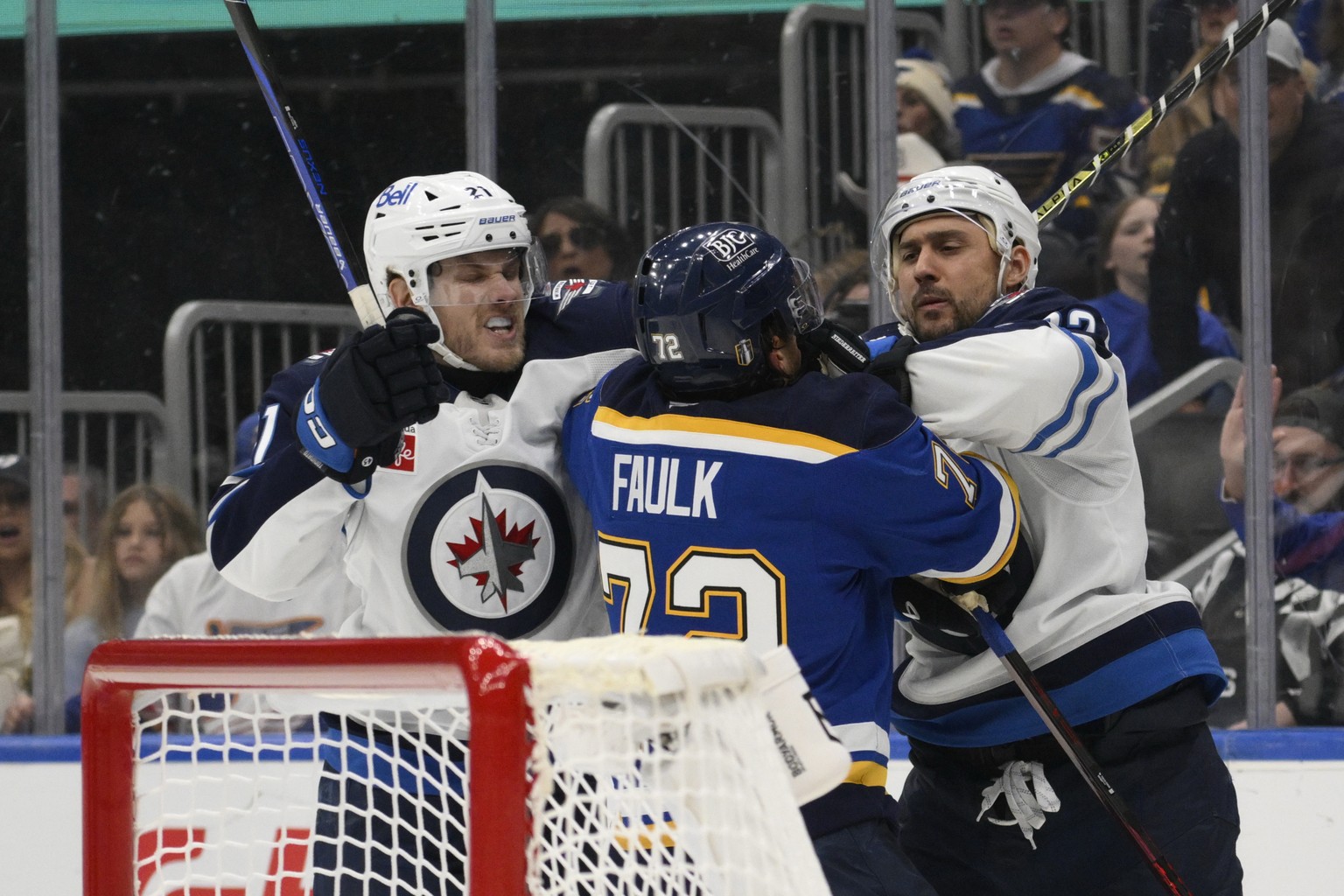 Winnipeg Jets center Dominic Toninato, left, and right wing Nino Niederreiter, right, get physical with St. Louis Blues defenseman Justin Faulk, center, during the third period in Game 6 of an NHL hoc ...
