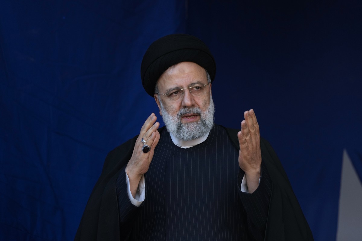 Iranian President Ebrahim Raisi waves to the crowd during the funeral ceremony of the victims of Wednesday's bomb explosion in the city of Kerman about 510 miles (820 kms) southeast of the capita ...