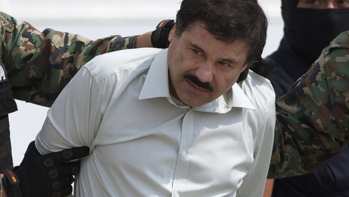FILE - This Feb. 22, 2014 file photo shows Joaquin "El Chapo" Guzman, the head of Mexico's Sinaloa Cartel, being escorted to a helicopter in Mexico City following his capture overnight  ...