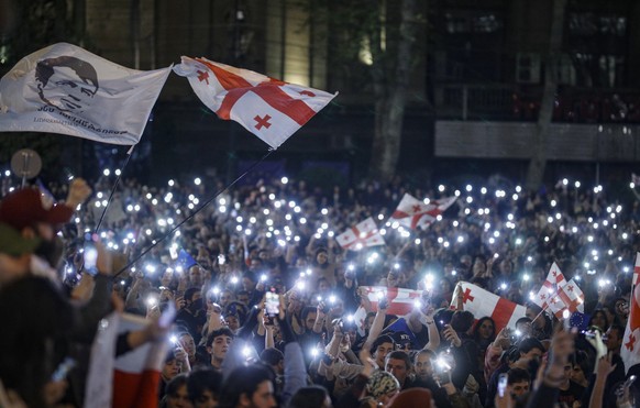 epa11282912 Georgian opposition party supporters attend a protest against a draft bill on &#039;foreign agents&#039; near the Georgian Parliament in Tbilisi, Georgia, 16 April 2024. The Georgian parli ...