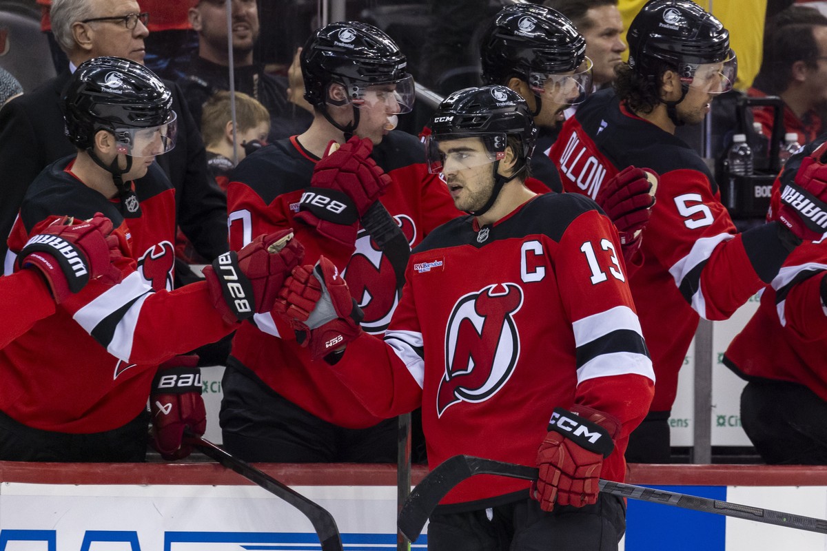 New Jersey Devils center Nico Hischier (13) celebrates at the bench after scoring a goal during the third period of an NHL hockey game against the Utah Hockey Club, Monday, Oct. 14, 2024, in Newark, N ...