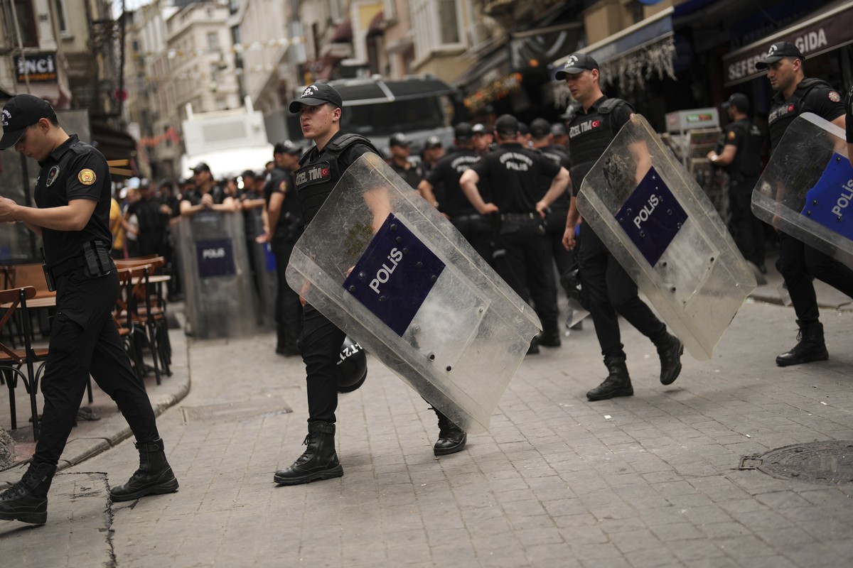 Police officers take position prior to a protest against satirical LeMan magazine after they published a cartoon that allegedly depicted the Prophet Muhammad, in Istanbul, Turkey, Tuesday, July 1, 202 ...