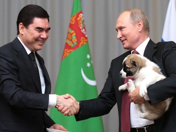 October 11, 2017 - Sochi, Russia - Russian President Vladimir Putin holds a Alabai puppy gifted him by Turkmen President Gurbanguly Berdymukhamedov, left, prior to their meeting in the Bocharov Ruchei ...