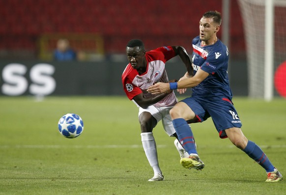 Salzburg's Diadie Samassekou, left, duels for the ball with Red Star's Nikola Stoiljkovic during the Champions League qualifying play-off first leg soccer match between Red Star and Salzburg on the st ...