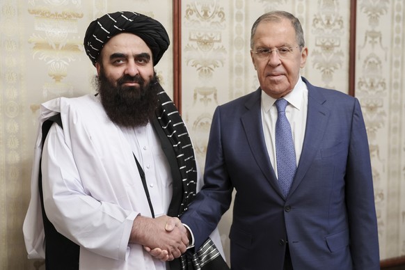FILE - In this photo released by Russian Foreign Ministry Press Service on Oct. 4, 2024, Russian Foreign Minister Sergey Lavrov, right, and Acting Foreign Minister of Afghanistan&#039;s Taliban moveme ...