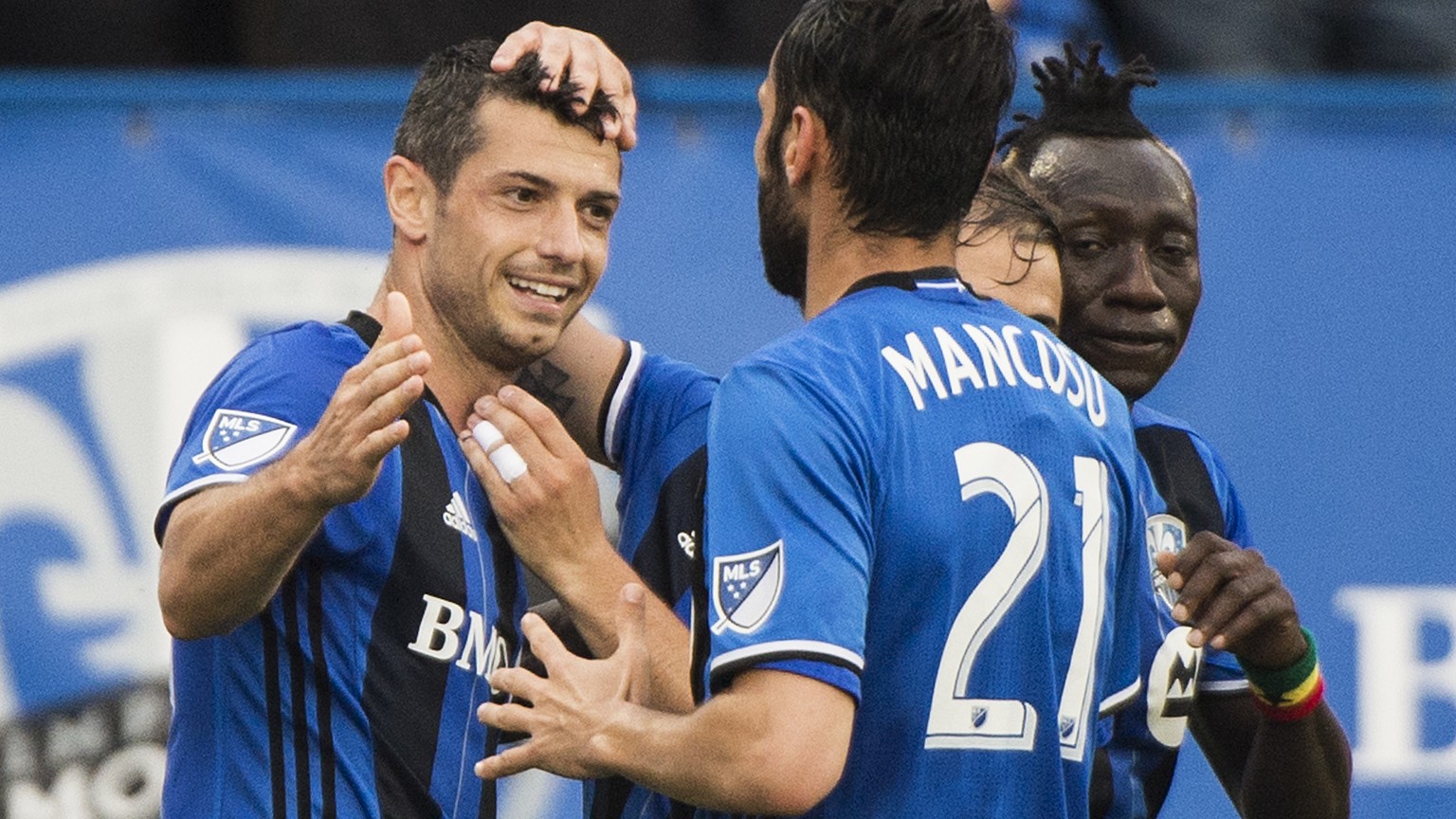 Montreal Impact&#039;s Blerim Dzemaili, left, celebrates with teammates after scoring against D.C. United during first half MLS soccer action in Montreal, Saturday, July 1, 2017. THE CANADIAN PRESS/Gr ...