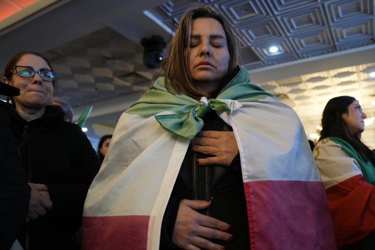 A woman draped in the Lion and Sun flag, observes a minute of silence , following a call by Iran's former empress, Farah Pahlavi, for a day of mourning for protesters killed by the Islamic Republ ...