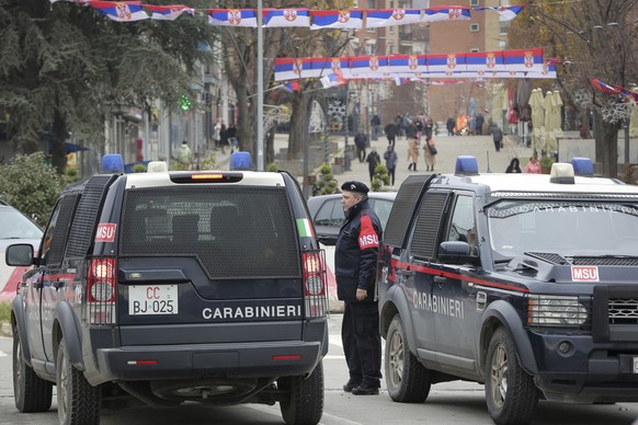 Italian carabinieri part of the KFOR peacekeeping mission in Kosovo guard the main bridge in ethnically divided town of northern Mitrovica on Friday, Dec. 9, 2022. Kosovo law enforcement on Friday sai ...