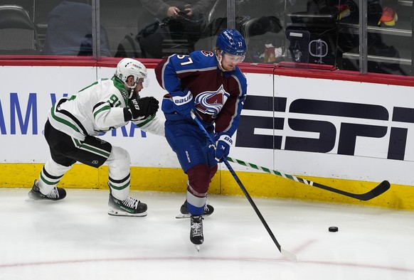 Dallas Stars center Tyler Seguin, left, reaches for the puck past Colorado Avalanche center Casey Mittelstadt during the third period of Game 4 of an NHL hockey Stanley Cup playoff series, Monday, May ...