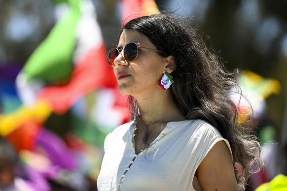 epa10333558 A demonstrator attends the Women Life Freedom protest in solidarity with citizens of Iran, outside Parliament House, in Canberra, Australia, 28 November 2022. After the death of Mahsa Amin ...