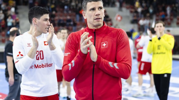 Switzerland&#039;s Andy Schmid, right, and Switzerland&#039;s Luka Maros, left, react after their vicotry in the 50. Yellow Cup Handball game between Switzerland and Bosnia and Herzegovina on Friday,  ...