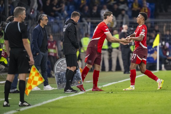 Switzerland's Dan Ndoye, right, leaves the pitch and is substituted by Cedric Itten, 2nd right, with Switzerland's head coach Murat Yakin, 2nd left, watching, during the FIFA 2026 World Cup  ...