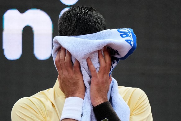 Serbia's Novak Djokovic wipes his face during a pause in his match against Croatia's Dino Prizmic at the Italian Open tennis tournament, in Rome, Friday, May 8, 2026. (AP Photo/Andrew Medich ...