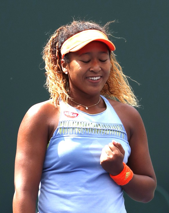 epa06613078 Naomi Osaka from Japan reacts after defeating Daria Kasatkina from Russia in their final match of the BNP Paribas Open at the Indian Wells Tennis Garden in Indian Wells, California, USA, 18 March 2018.  EPA/MIKE NELSON
