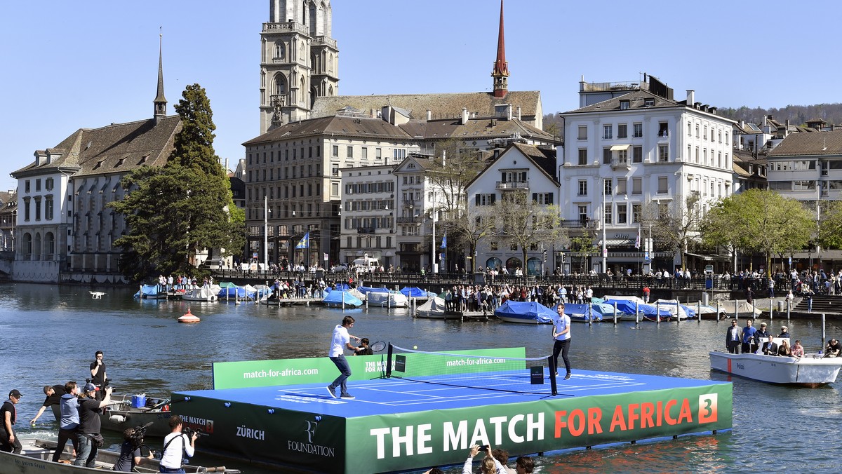 Roger Federer, left, and Andy Murray, right, play tennis on the lake Zurich, in Zurich, Switzerland , Monday, April 10, 2017. "The Match for Africa 3", the third charity tennis event for the ...