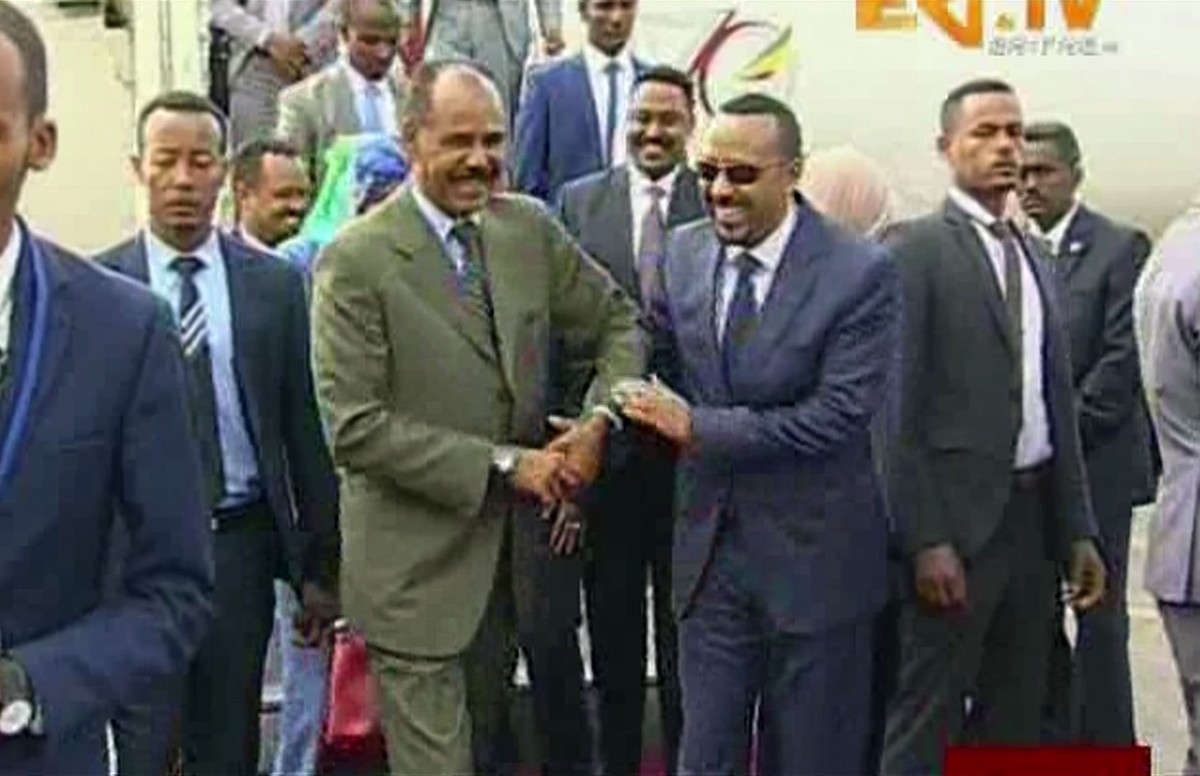 In this grab taken from video provided by ERITV, Ethiopia's Prime Minister Abiy Ahmed, centre right is welcomed by Erirea's President Isaias Afwerki as he disembarks the plane, in Asmara, Er ...