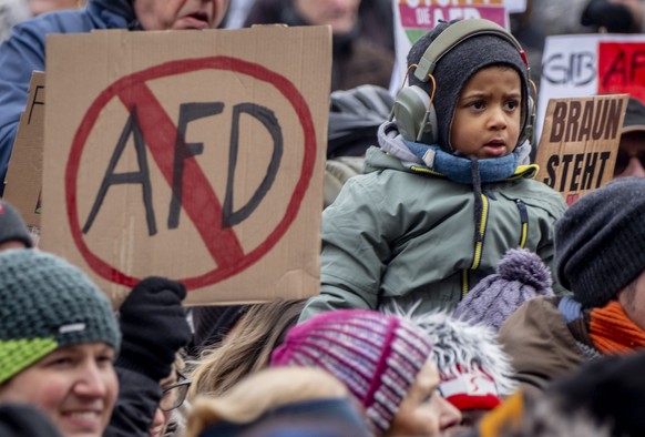 FILE - People gather as they protest against the AfD party and right-wing extremism in Frankfurt/Main, Germany, Saturday, Jan. 20, 2024. Germany?s president has called for a broad ?alliance against ex ...