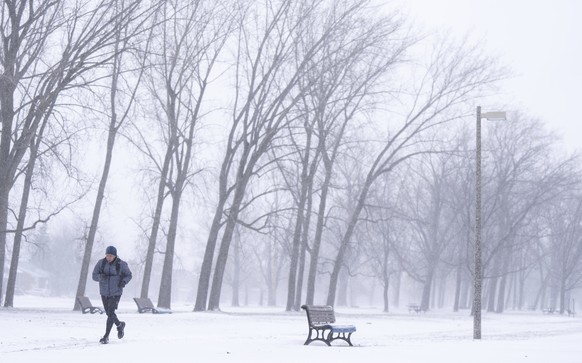 A man jogs through a park in Montreal, Wednesday, Jan. 8, 2025. (Christinne Muschi/The Canadian Press via AP)