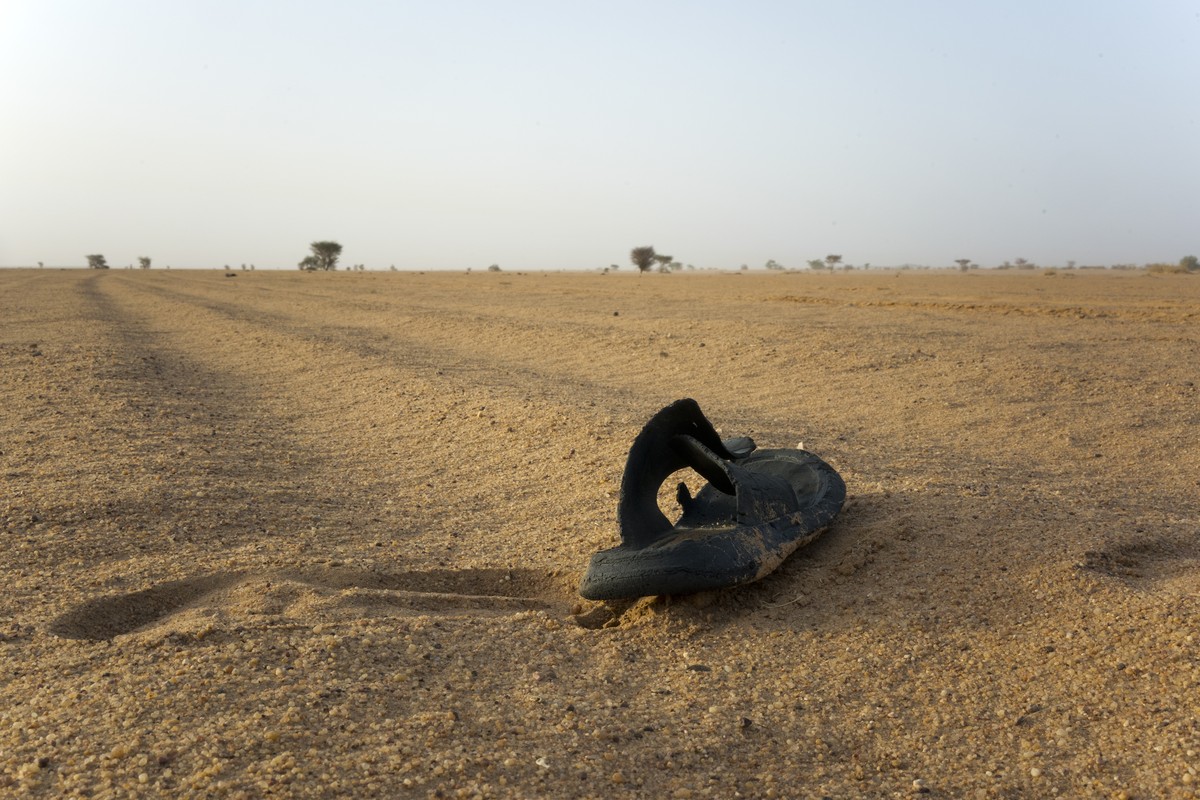 A sandal lies on the ground in Niger's Tenere desert region of the south central Sahara on Sunday, June 3, 2018. (AP Photo/Jerome Delay)