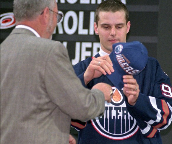 First round pick Switzerland&#039;s Michel Riesen looks at the team cap after being selected by Edmonton in the NHL draft in Pittsburgh Pa. Saturday June 21, 1997. (AP Photo/Gene J. Puskar)