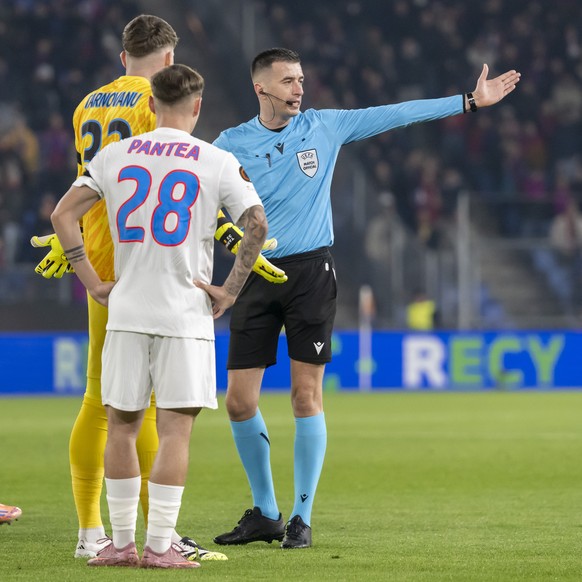 Albanian referee Juxhin Xhaja, right, sends goalkeeper Stefan Tarnovanu (FCSB) off the pitch during the UEFA Europa League league phase round 4 match between Switzerland&#039;s FC Basel 1893 and Roman ...
