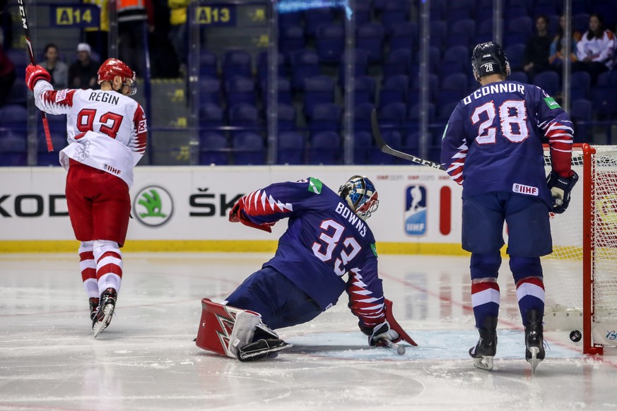 epa07570184 Peter Regin of Denmark (L) in action against goalkeeper Ben Bowns of Great Britain (C) during the IIHF World Championship group A ice hockey match between Great Britain and Denmark at the  ...